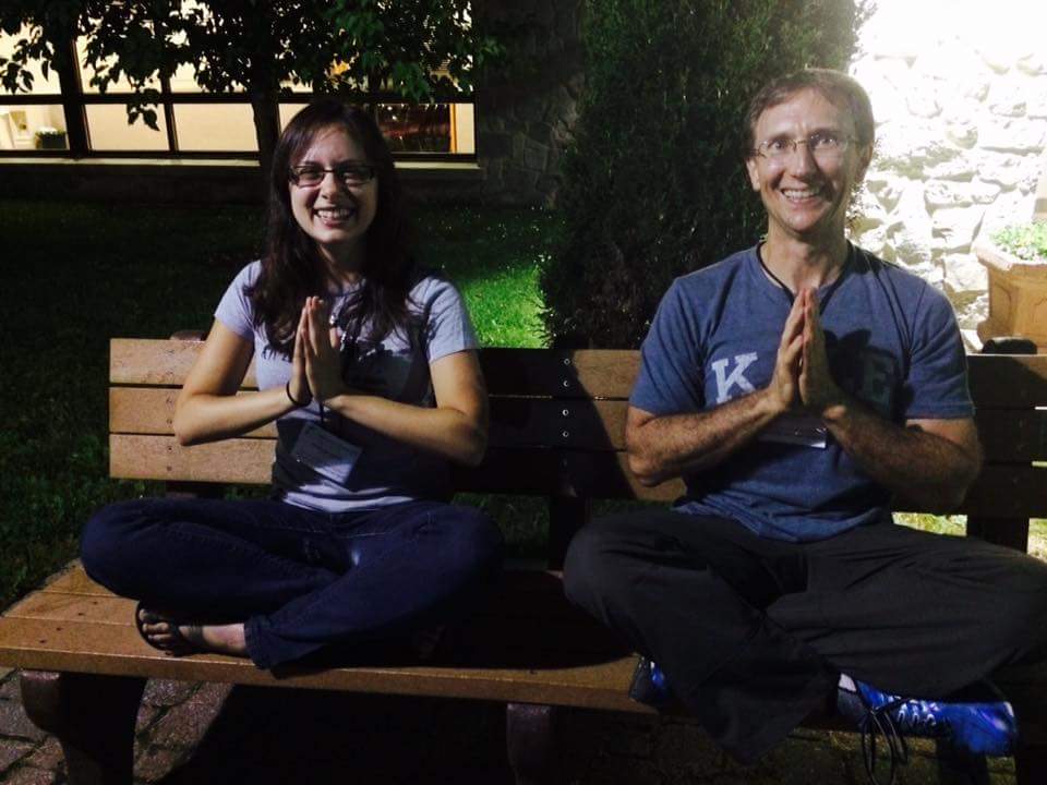 LWH Founder JP sitting with assistant Mariam showing namaste hands